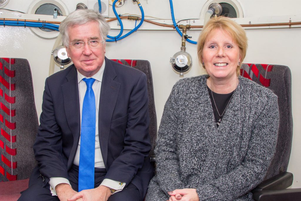 Michael Fallon MP inside the oxygen therapy chamber with manager Deborah Clarke