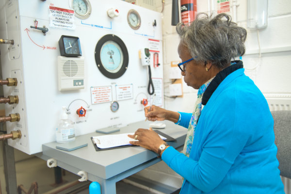 A volunteer operates the Oxygen Chamber controls
